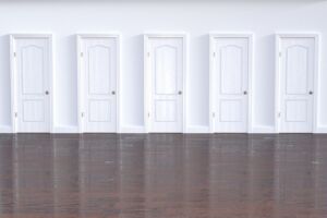 5 white doors representing choices